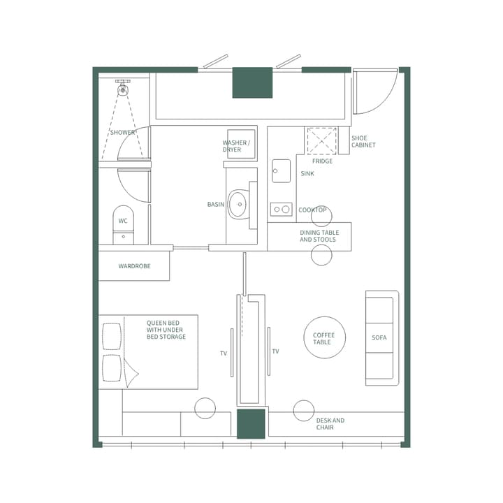 Detailed floor plan illustration of the One Bedroom Luxe Suite with English labels, showing the clear separation between the living room (Sofa, Coffee Table, Desk) and the bedroom (Queen Bed, Wardrobe) by a dividing wall with a TV mount.