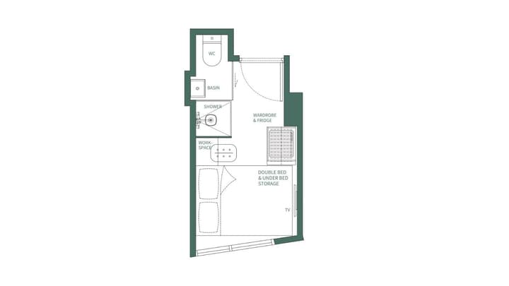 A black and white floor plan diagram for a Studio Single Plus unit, showing a double bed with under-bed storage, a workspace, wardrobe, fridge, and an attached private bathroom with a shower and toilet.