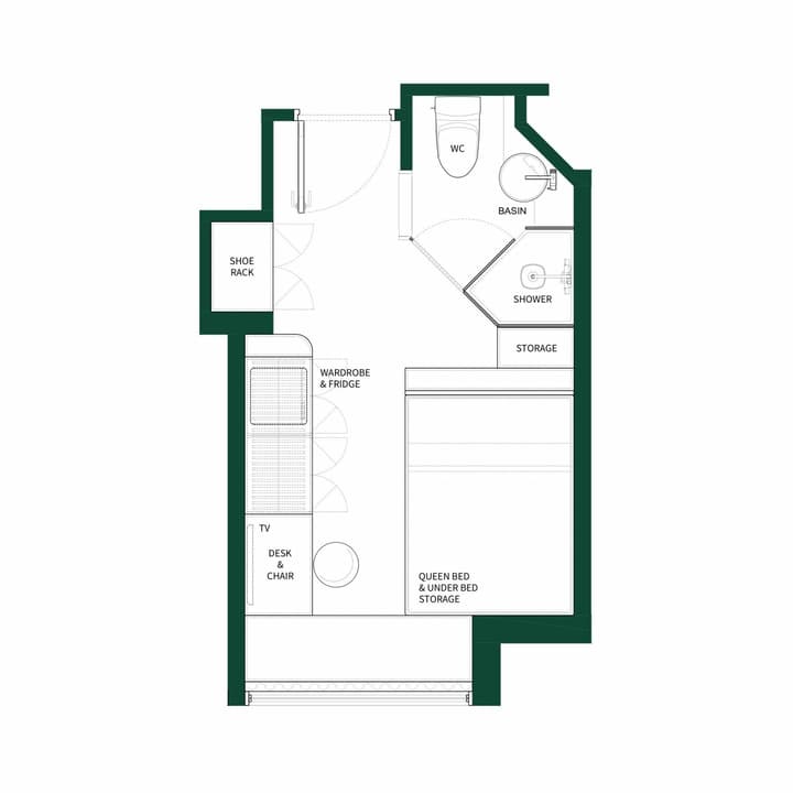 Black and white floor plan diagram for a small studio unit with a queen bed and under-bed storage. The efficient layout includes a desk and chair, a wardrobe and fridge area, a separate shower, basin, and WC bathroom, and a shoe rack near the entry.