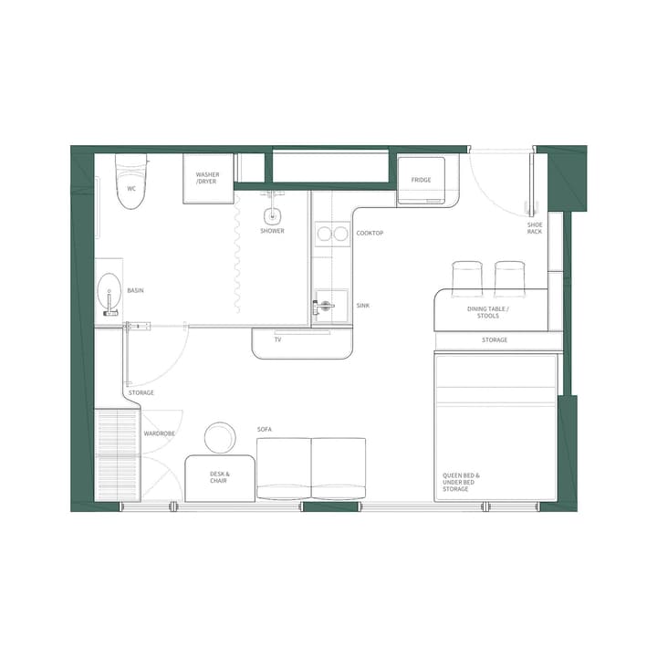 Floor plan for a Studio Premier unit showing separate areas for the queen bed, sofa, desk, and a full kitchen/dining area with a cooktop, sink, fridge, and washer/dryer unit.