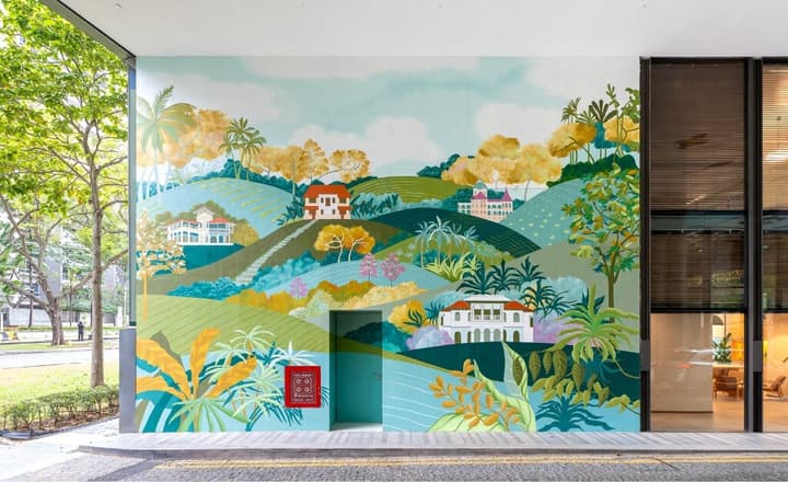 Close-up of a large, vibrant, hand-painted tropical landscape mural on the building's facade, featuring colorful hills, historical houses, and lush foliage.