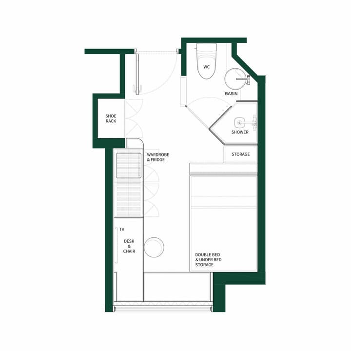 Black and white floor plan diagram for a small studio unit with a double bed and under-bed storage. The layout includes a desk and chair, a wardrobe and fridge area, a separate shower and WC bathroom, and a shoe rack by the entrance.