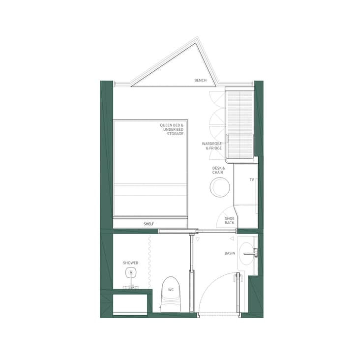 Floor plan for a Studio Queen unit, showing a queen bed with under-bed storage, a desk, wardrobe/fridge unit, and a bathroom with a shower and WC. The main room features a triangular bench area, suggesting a corner window.