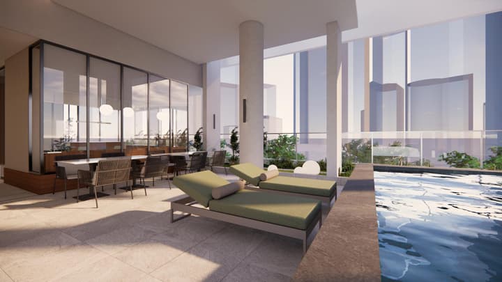 A luxurious outdoor lounge area with olive-green daybeds next to a small pool, featuring a shaded dining area behind glass and a modern city skyline backdrop.