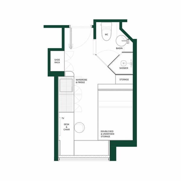 Black and white floor plan diagram for a small studio unit with a double bed and under-bed storage. The layout includes a desk and chair, a wardrobe and fridge area, a separate shower and WC bathroom, and a shoe rack by the entrance.