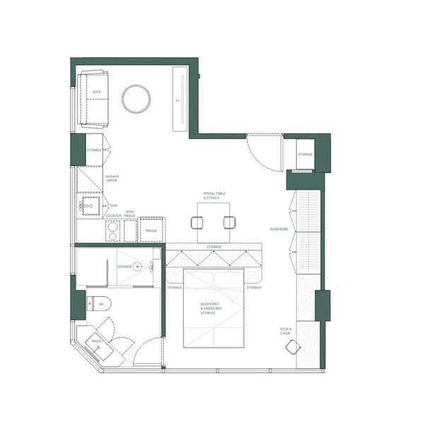 Top-down floor plan layout of a one-bedroom apartment suite showing an open-concept design with a queen bed, a desk, a full kitchen with a washer/dryer unit, a separate living area with a sofa, and a three-piece bathroom.